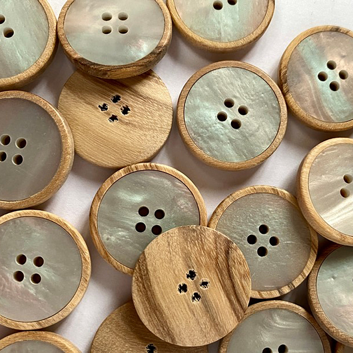 Button with pale wood base and pearly poly insert