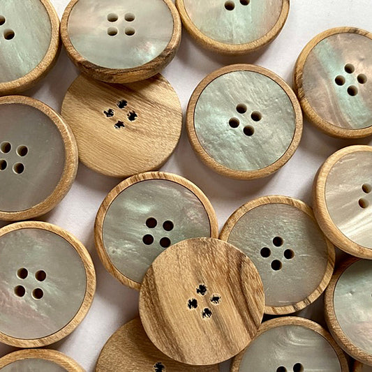 Button with pale wood base and pearly poly insert