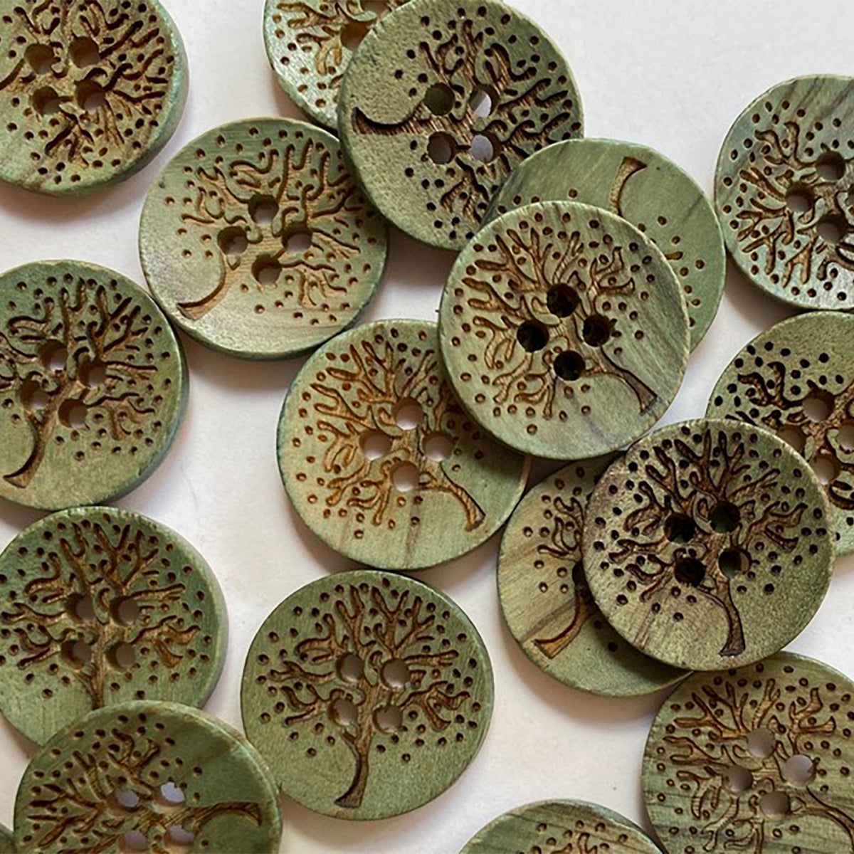 Green wooden button with laser tree